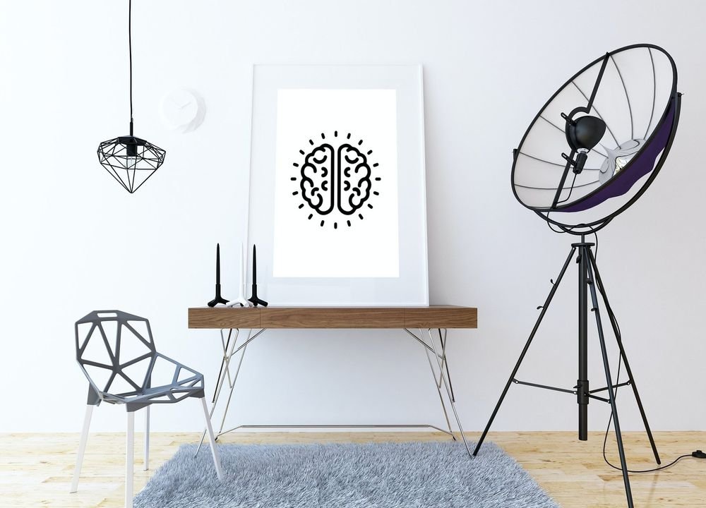 The brain mark print leaning on a walnut desk in a bright studio
